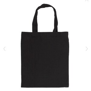 May include: A solid black tote bag with two matching handles. The bag is made of a plain, matte material and is designed for carrying items. The handles are attached at the top of the bag, allowing it to be carried by hand or over the shoulder.