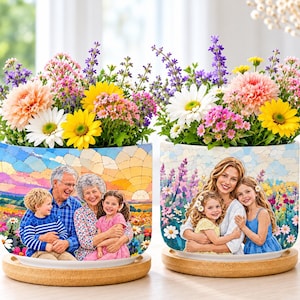 May include: Two cylindrical ceramic planters with bamboo saucers, each featuring a custom photo print. The left planter shows a family portrait against a sunset landscape. The right planter displays a mother and two daughters in a floral field.