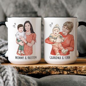 May include: Two white ceramic mugs with black handles. The mugs feature illustrations of a mother and child, and a grandmother and child. The text "Mummy & Kristen" and "Grandma & Finn" is printed on the mugs.
