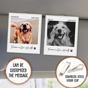 May include: Two white photo frames with black borders and a black and white photo of a dog in each frame. The frames are attached to a car visor with silver clips. The text on the frames reads "Domino 2019-2025" and "Bella 2020-2025". The text below the photos reads "Forever in Our Hearts".