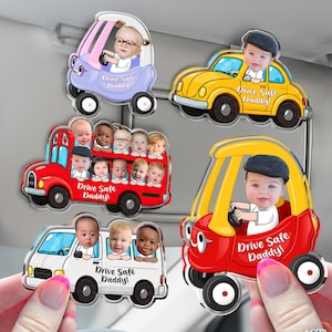 May include: A collection of car-shaped magnets featuring images of babies. The magnets are in various colors, including yellow, red, white, and purple. Each magnet has the text "Drive Safe Daddy!"