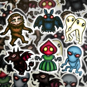 Puede incluir: Un conjunto de nueve pegatinas coloridas con varias criaturas míticas, incluyendo un yeti marrón, un murciélago azul con ojos rojos, un par de fantasmas blancos, un robot rojo con capucha, un demonio negro y rojo y un extraterrestre azul.