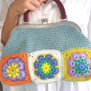 Made with 100% cotton yarn, this unique frame bag features colorful granny square motifs on both sides, creating a bold and playful look.