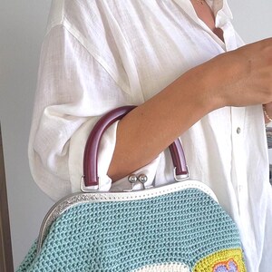 Add a touch of vintage charm to your wardrobe with this beautifully handcrafted crochet bag.