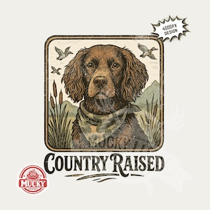 May include: A brown dog illustration with a bandana, set in a rectangular frame with a distressed look. The image includes the text "COUNTRY RAISED" and a logo. Ducks and cattails are also featured.