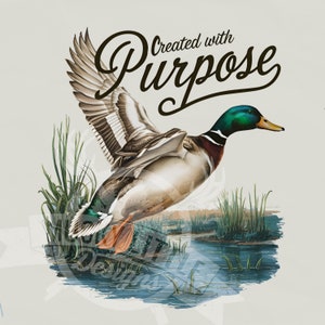 May include: A green-headed mallard duck with brown and white feathers is flying over a pond with green reeds. The duck is in mid-flight with its wings spread wide. The text "Created with Purpose" is written in a brown cursive font above the duck.