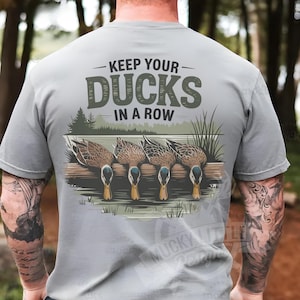 May include: A gray t-shirt with a graphic of ducks in a row and the text "Keep Your Ducks In A Row".