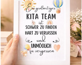 May include: A white framed print featuring the German text 'Ein großartiges KITA TEAM ist schwer zu finden, hart zu verlassen und unmöglich zu vergessen'. The design includes watercolour illustrations of a sun, a hot air balloon, a rainbow, and a heart.