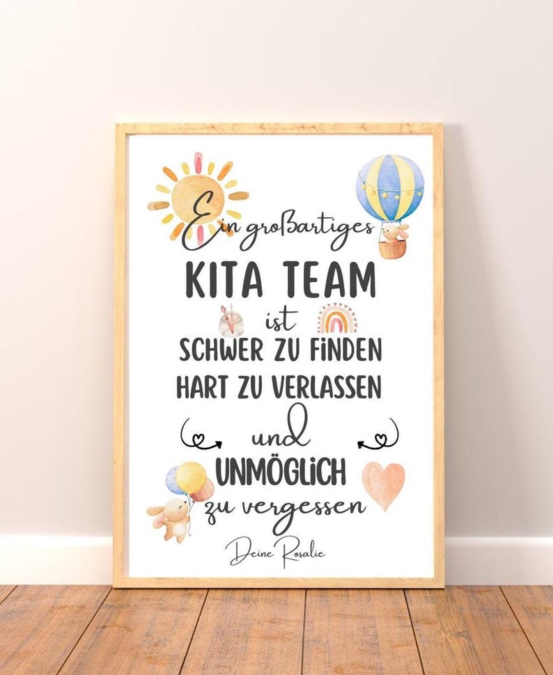 May include: A framed print with the text "Ein gro&szlig;artiges KITA TEAM ist SCHWER ZU FINDEN HART ZU VERLASSEN und UNM&Ouml;GLICH zu vergessen Deine Rosalie." The print features watercolor illustrations of a sun, hot air balloon, rainbow, and heart.