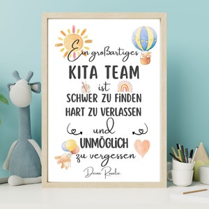 May include: A framed print with a light wood frame features the text "Ein gro&szlig;artiges KITA TEAM ist SCHWER ZU FINDEN HART ZU VERLASSEN und UNM&Ouml;GLICH zu vergessen Deine Rosalie." The print includes watercolor illustrations of a sun, hot air balloon, and a teddy bear.