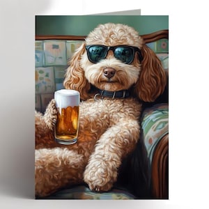 May include: A humorous greeting card showing a poodle wearing sunglasses and a black collar, holding a pint of beer. The dog is seated on a patterned armchair. The image has a lighthearted theme.
