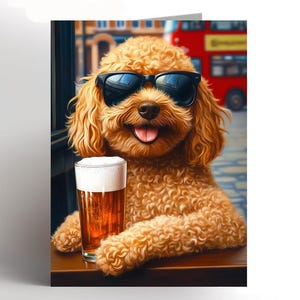 May include: A greeting card showing a light brown poodle wearing black sunglasses, holding a pint of beer. The dog is smiling with its tongue out. The background shows a city street and a red double-decker bus.