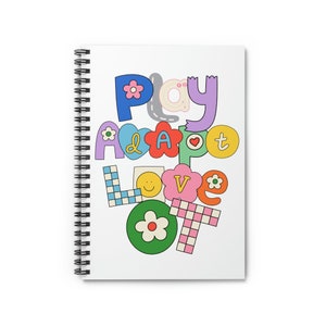 May include: A white spiral notebook with the words "Play Adopt Love OT" written in colorful letters with various patterns and designs. The letters are arranged in a vertical stack.