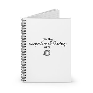 May include: White spiral bound notebook with the text "in my occupational therapy era" and a disco ball graphic.