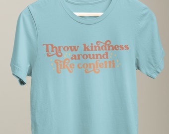 May include: A light blue t-shirt with the text "Throw kindness around like confetti" in a peachy orange colour.