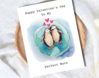 May include: A Valentine's Day card featuring two watercolor penguins on an iceberg, with the text "Happy Valentine's Day To My Perfect Mate." Pink hearts float above the penguins, set against a white background.