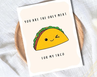 May include: A greeting card with a cartoon taco illustration. The taco is yellow with green and red accents, winking with a smiling face. The text reads, "YOU ARE THE ONLY MEAT FOR MY TACO."