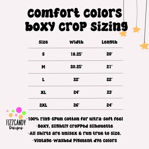 May include: A pink graphic with the text "comfort colors boxy crop sizing." The chart shows shirt sizes S to 2XL with width and length measurements in inches. Additional text describes the shirts as unisex, made of ring-spun cotton, and vintage-washed.