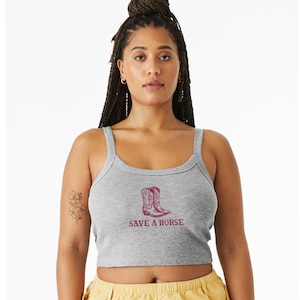 May include: A gray cropped tank top with a red graphic of cowboy boots and the text "SAVE A HORSE".