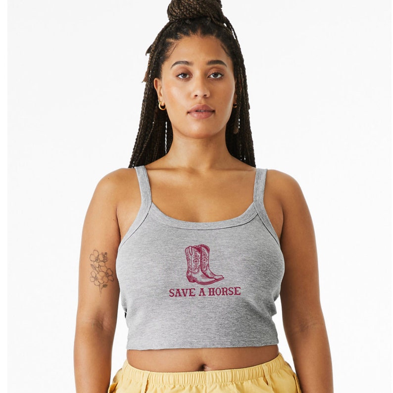 May include: A gray cropped tank top with a red graphic of cowboy boots and the text "SAVE A HORSE".
