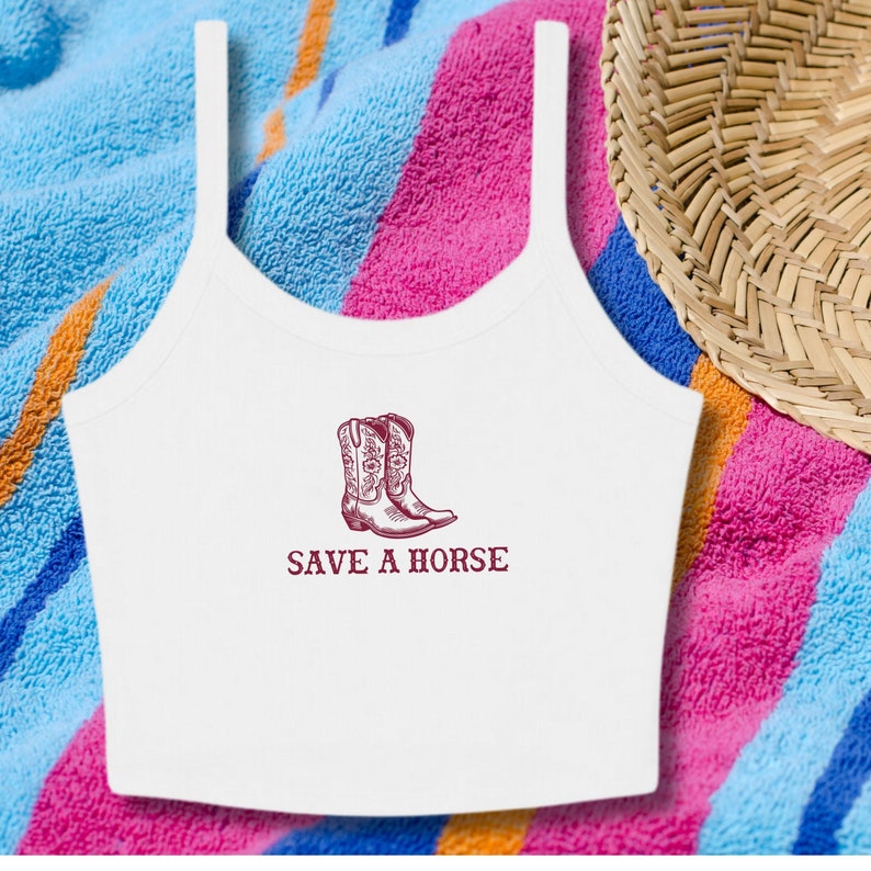 May include: White tank top with a maroon graphic of cowboy boots and the text "SAVE A HORSE".