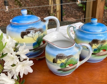 vintage tea set (rustic lakeside scene; pot, sugar, and creamer handpainted in Japan)