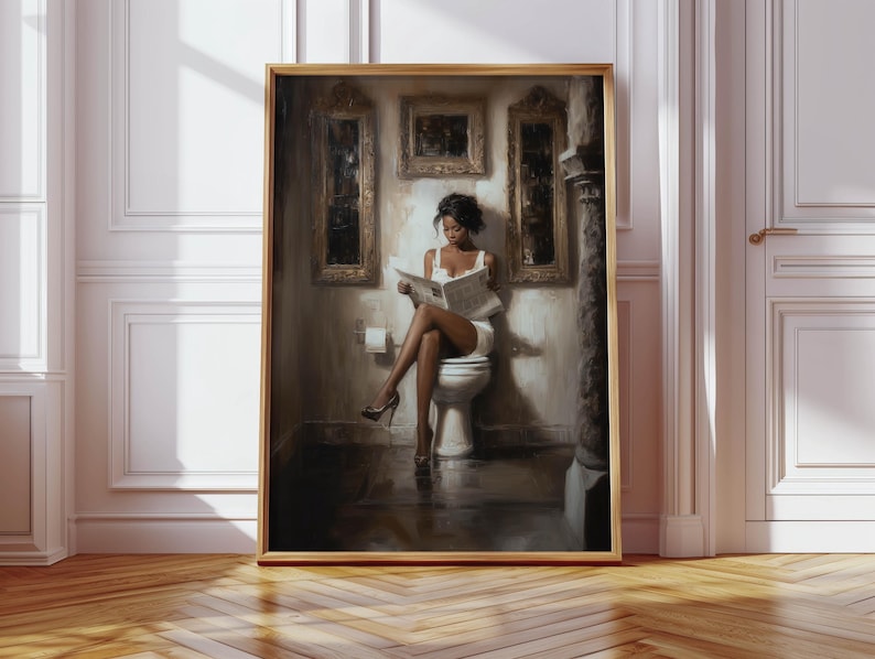 May include: A framed artwork shows a person in a white dress reading a newspaper while seated on a toilet. The artwork is set in a bathroom with ornate wall decor and a wooden frame. The colour palette is muted with warm tones.