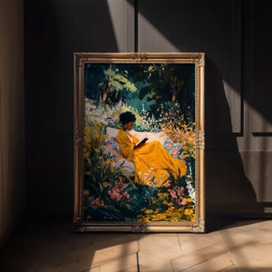 May include: A framed painting depicts a person in a yellow dress reading a book while reclining on a white cushion surrounded by flowers and foliage. The artwork has a gold ornate frame and is displayed indoors.