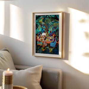 May include: A framed art print showing a colourful outdoor scene. A group of people are gathered around a table, laden with food, beneath a large tree. The artwork has a gold frame and is mounted on a white wall.