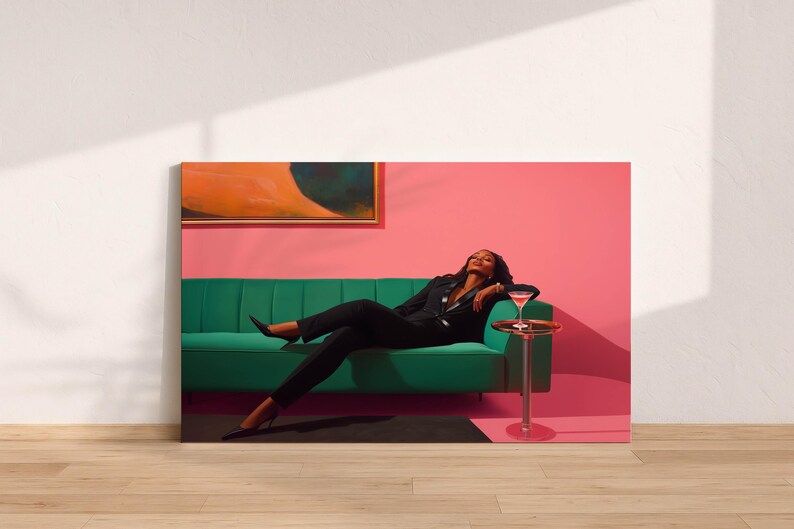 May include: A canvas print featuring a person in a black suit relaxing on a green sofa. A cocktail sits on a small side table. The background is a pink wall with an abstract painting.