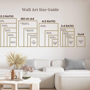 May include: A wall art size guide with different ratios and measurements in inches and centimeters. The guide includes 2:3, ISO A1-A4, 4:5, 3:4, and 11x14 ratios. The guide is displayed on a white wall with a couch and a table in the foreground.