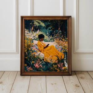 May include: A framed art print depicts a person in a yellow dress reading in a garden. The artwork features a person reclining on a white bench surrounded by colorful flowers and lush greenery. The frame is a warm brown color.