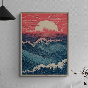 May include: A framed print of a stylized ocean scene with a large, pink sun setting over the waves. The print is hanging on a white wall above a wooden cabinet with a record player, a red chair, and decorative objects.