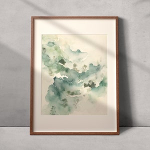 May include: A framed watercolor painting of a landscape with green and blue hues. The painting depicts a misty, forested scene with trees and hills.