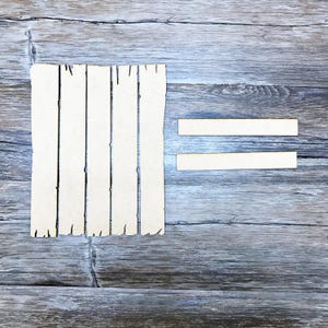 May include: A set of five wooden slats with a rough, unfinished texture, arranged vertically. Two smaller wooden slats are placed horizontally below the vertical slats, creating an equals sign.