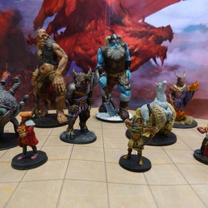 May include: A collection of fantasy miniature figurines, including a cyclops, a minotaur, a giant, a frost giant, a winged horse, a demon, a human archer, and a human mage. The figurines are painted in various colors and are standing on a brown and white gridded surface.