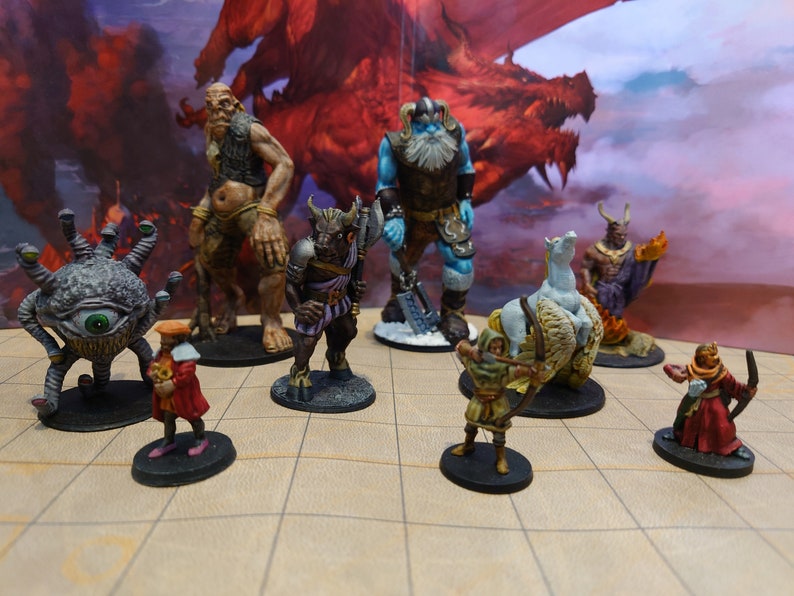 May include: A collection of fantasy miniature figurines, including a cyclops, a minotaur, a giant, a frost giant, a winged horse, a demon, a human archer, and a human mage. The figurines are painted in various colors and are standing on a brown and white gridded surface.