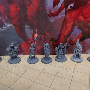 May include: Seven gray plastic miniature figurines of fantasy characters, including a goblin, a cat-like creature, a knight, a wizard, a sorcerer, a dwarf, and a human warrior. The figurines are standing on a gray and white checkered surface.