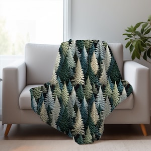 May include: A soft, plush throw blanket featuring a repeating pattern of stylized evergreen trees in shades of green, blue, and cream on a dark background.