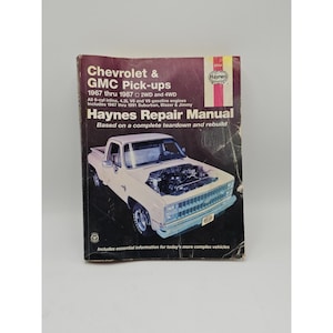 Può includere: Un manuale di riparazione Haynes per Chevrolet & GMC Pick-up dal 1967 al 1987. La copertina presenta un pick-up bianco con il cofano aperto. Il manuale include informazioni sui motori a benzina a 6 cilindri in linea, V6 e V8.