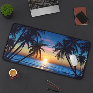 May include: A rectangular desk mat featuring a tropical sunset scene with palm trees silhouetted against a vibrant sky. The design includes a bright orange sun over the ocean, with a white computer mouse on the mat.