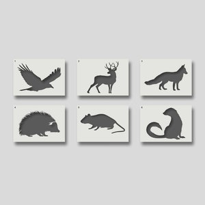 May include: Six black and white silhouette stencils of animals: a crow, a deer, a fox, a hedgehog, a rat, and a weasel. The stencils are numbered 1 through 6.