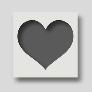 May include: A white square card with a grey heart cut out of the centre. The heart is a simple shape with a rounded top and bottom.