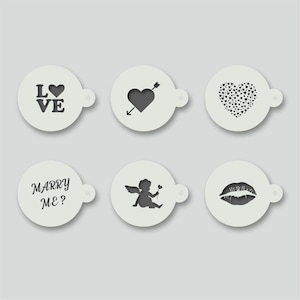 May include: Six white round stencils with black designs for Valentine's Day. The designs include: "LOVE" with a heart, a heart with an arrow, a heart filled with small hearts, "MARRY ME?", a cupid with wings and a flower, and a pair of lips.
