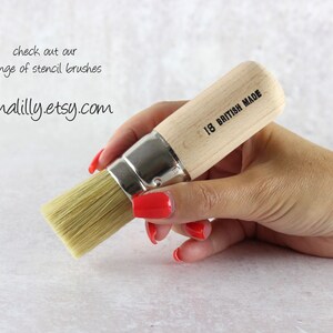 May include: A close-up of a small, wooden-handled stencil brush with natural bristles. The handle is labeled "1/8 British Made".