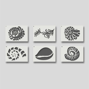 May include: Six black and white stencils of seashells and seaweed. The stencils are numbered 7 through 12.