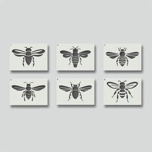 May include: Six different bee stencils, each with a unique design. The stencils are numbered 1 through 6. The bees are all black and have wings, a body, and legs.