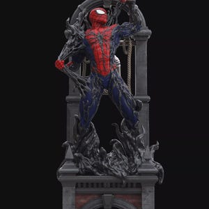 Peut inclure: Une statue détaillée représentant une silhouette en transition entre un costume rouge et bleu à motifs d'araignée et une forme symbiotique noire et visqueuse. La figurine repose sur une base architecturale en pierre avec une arche en brique.