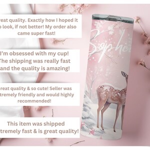 May include: A pink stainless steel tumbler with a white deer and snowflakes design. The tumbler has the name "Sophia" written on it in white cursive.