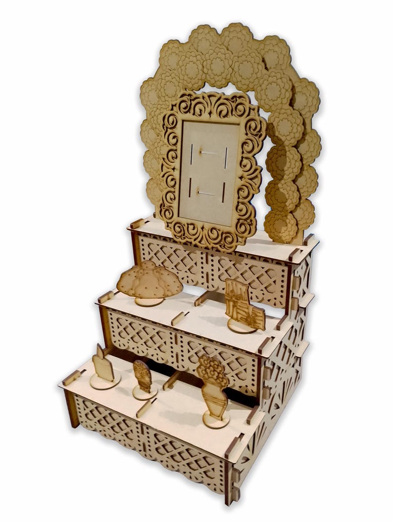 May include: A three-tiered wooden display stand with intricate cutouts and a decorative frame at the top. The stand is designed for displaying small items, such as candles, flowers, and other decorative objects.